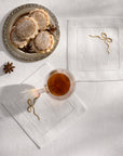 Regalo white/beige cocktail napkins with a plate of cookies