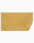 Bello Nuovo tub mat in wheat with its corner flipped up