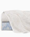 Isabella quilt in ivory/sand and ivory/sea stacked and folded