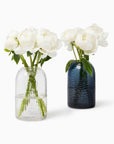 Oculus vase in clear and smoke with white flowers