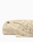 Palatino sand quilt folded on white background