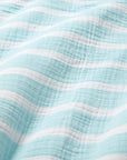 Close-up of a textured fabric with light blue and white stripes