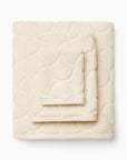 Oasi ivory bath towel, hand towel, and wascloth folded and stacked