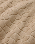 Close-up of textured oasi sand bath linens