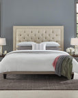 A queen size bed with a grey SFERRA Abriana Duvet Cover, pillows, shams, and a multi-colored throw.