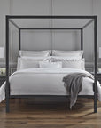 An all-white bed with SFERRA Giza 45 Sateen bedding, grown in the Nile river valley, woven by master craftsmen in Italy, and made of the finest cotton in the world