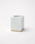 Gold-trimmed marble toothbrush holder against a white background.