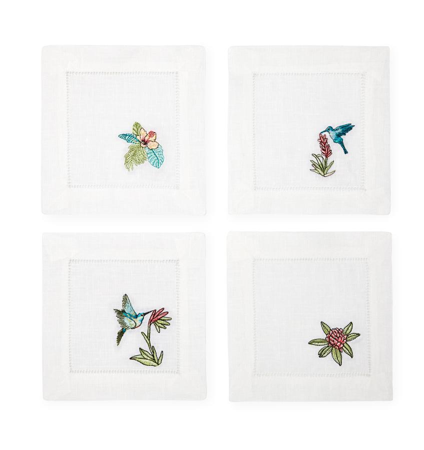 Inspired by the tropics, these whimsical cocktail napkins feature flora and birds embroidered against white hemstitched linen.
