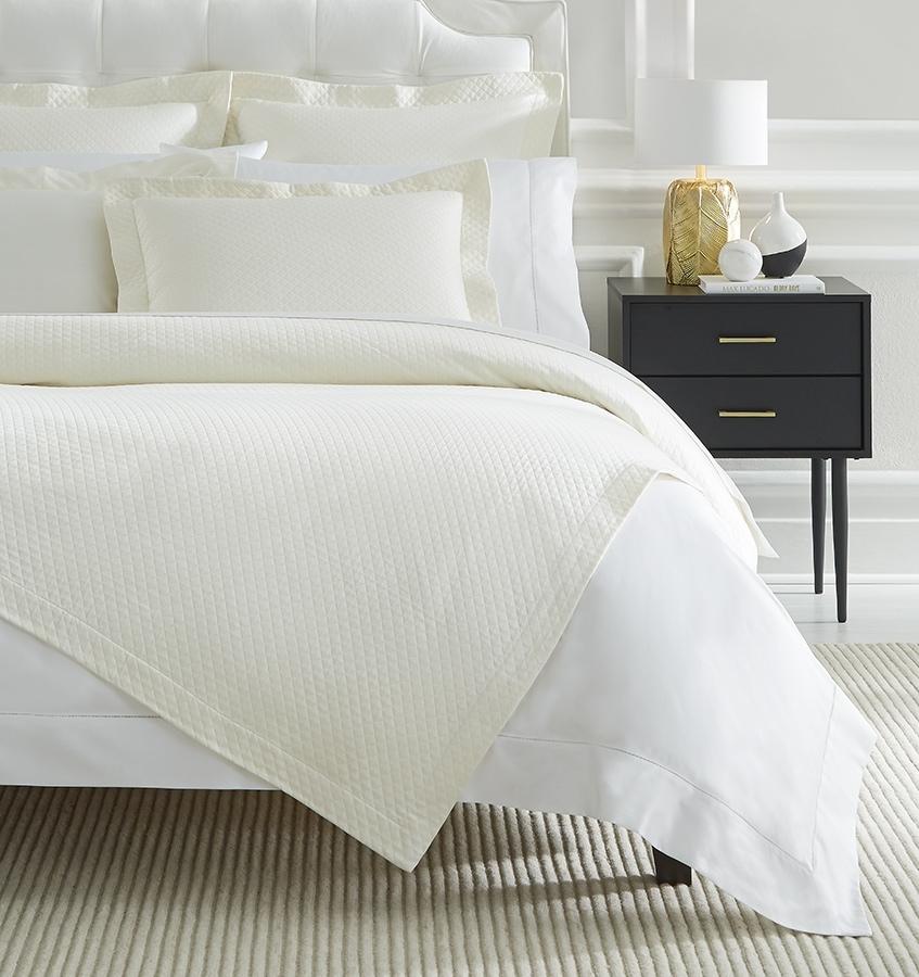 A luxury SFERRA bed skirt with a diamond piqué pattern. The Bari Collection is available in an array of pastel colors.