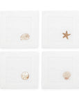 SFERRA Beachcomber cocktail napkins feature four delightful seashell embroideries in golden hues on hemstitched linen napkins.