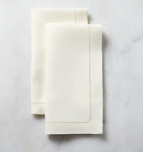 The SFERRA Classico napkin is our finest linen, woven with a border of delicate, refined hemstitching. Each thread is drawn by hand creating heirloom table linens to last for generations.