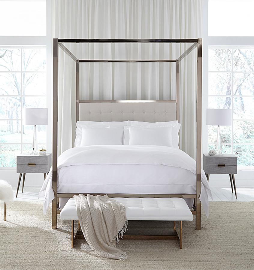 An all-white bed with SFERRA Giza 45 Sateen bedding, grown in the Nile river valley, woven by master craftsmen in Italy, and made of the finest cotton in the world