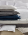 SFERRA Perrio Coverlet with a stack of Perrio Shams