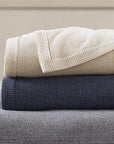 The SFERRA Talida Blanket, a traditional waffle weave with two tonal shades. It is woven with the finest Merino wool.