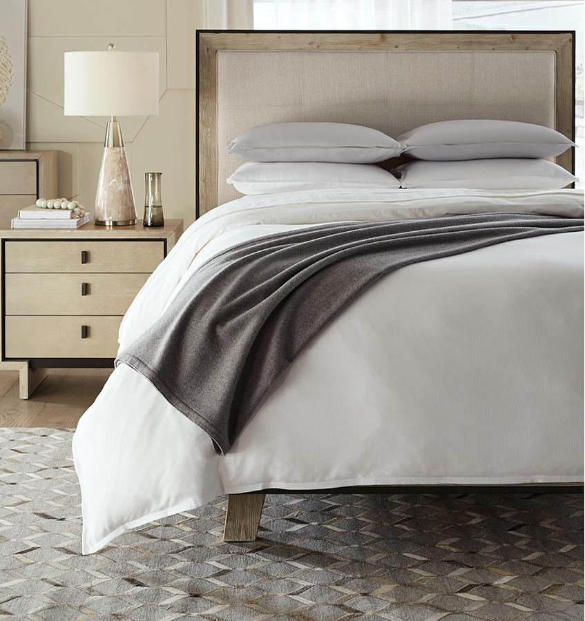 SFERRA Vimmo Blanket Cover in Grey draped on an all-white bed