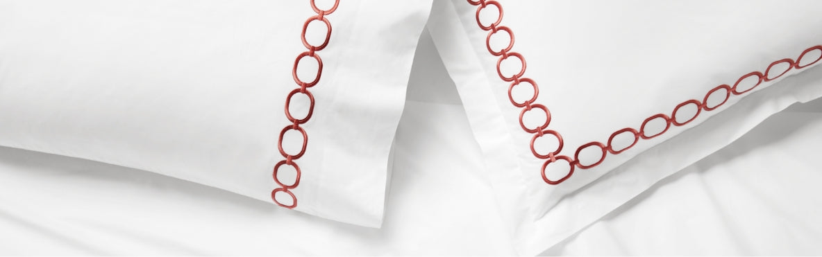 A close-up shot of a bed with pink bedding.