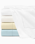Stack showing Ariel flat sheet folded in all colors. Top to bottom: White, oyster parchment & artic. 