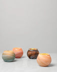 Giove votive candle holders lit with a candle inside