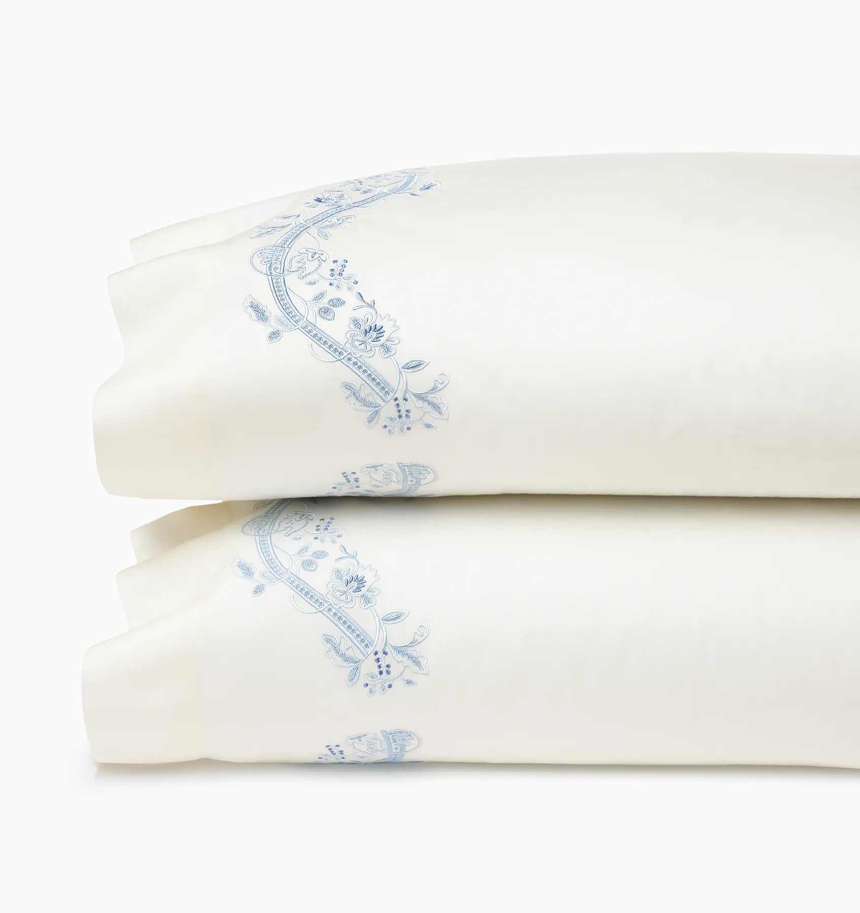 Isabella Ivory/Sea pillowcase pair stacked.