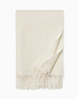 Terranova ivory throw blanket on a white background