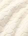 Close-up of textured oasi ivory bath linens