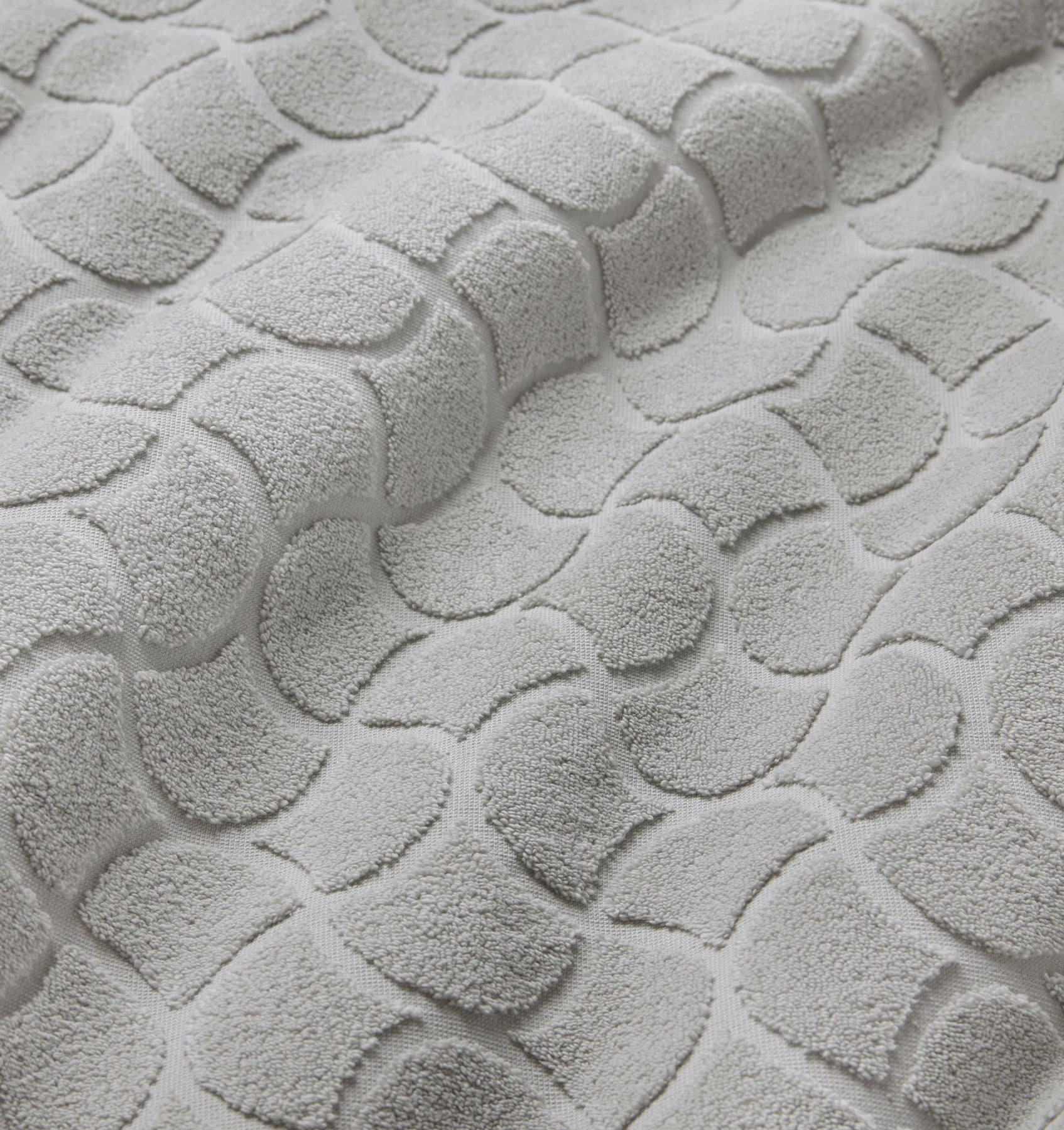 Close-up of textured oasi platinum bath linens