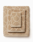 Oasi sand bath towel, hand towel, and wascloth folded and stacked 