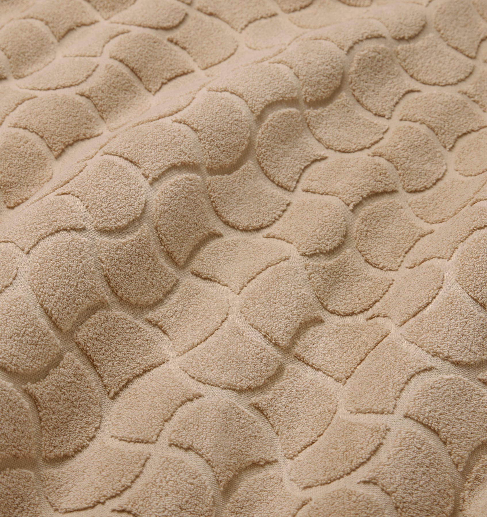 Close-up of textured oasi sand bath linens