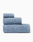 Oasi sea bath towel, hand towel, and wascloth folded and stacked side view