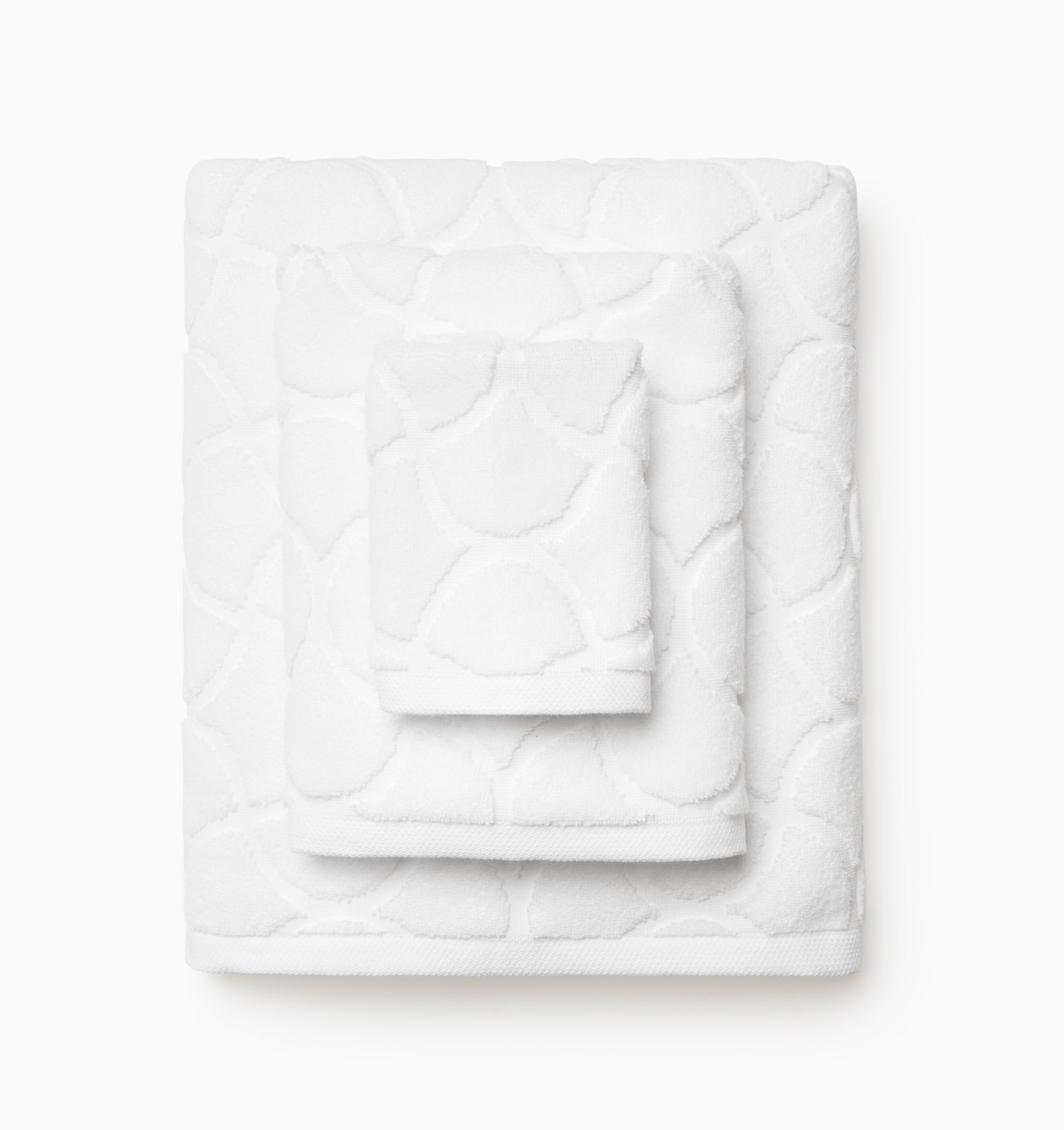 Oasi white bath towels stacked, top to bottom: washcloth, hand towel, bath towel. 