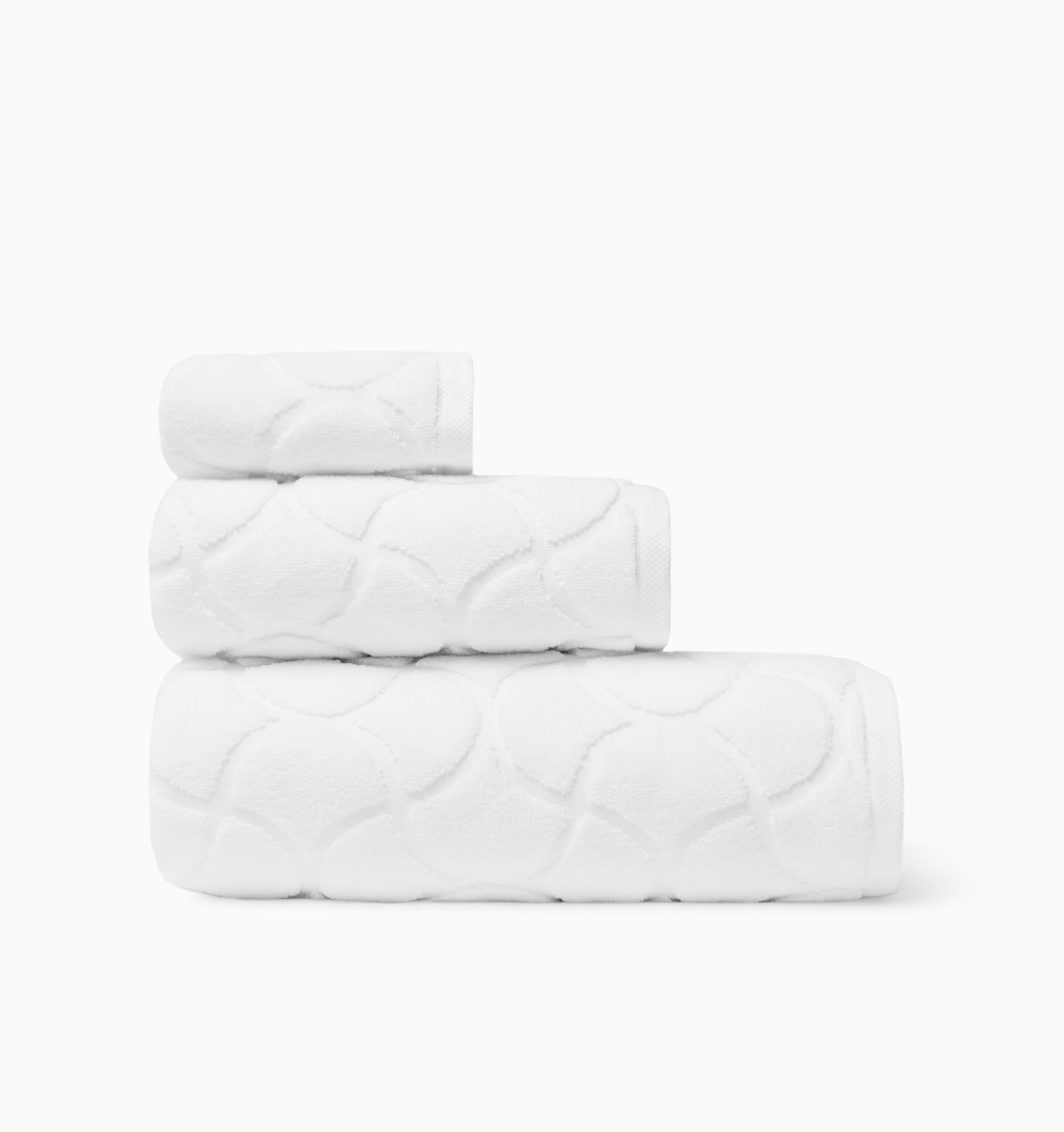 Oasi white bath towel, hand towel, and wascloth folded and stacked side view