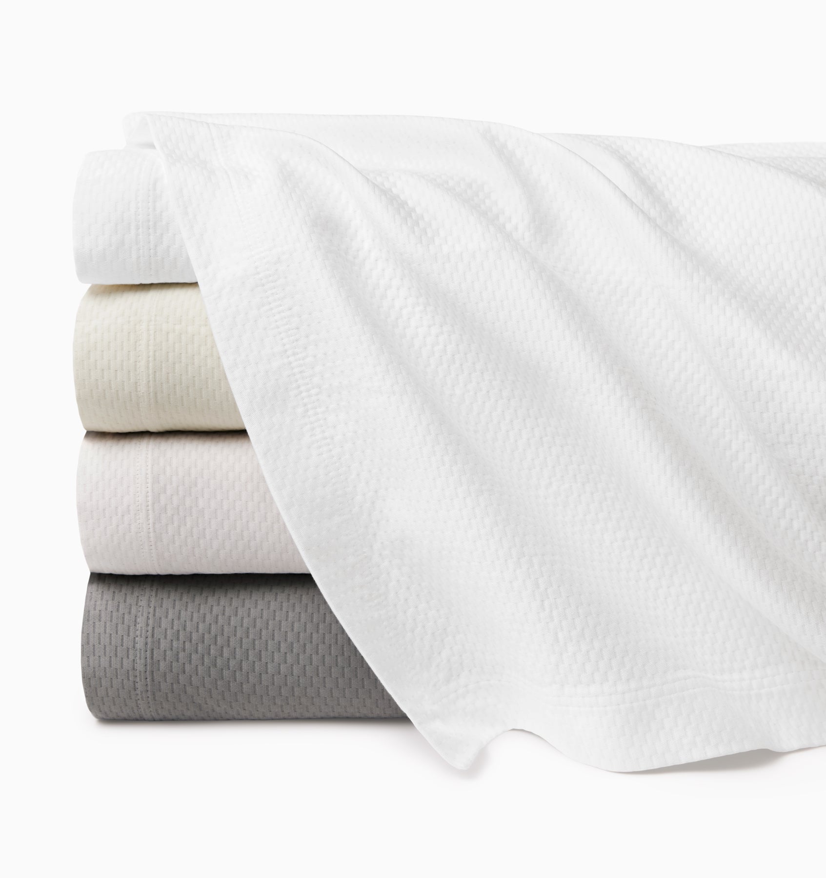 Perrio coverlet stack top to bottom: white, ivory, bone, silver.