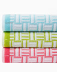 Stack of the Tirreno beach towels top to bottom clearwater, kiwi, coral labeled