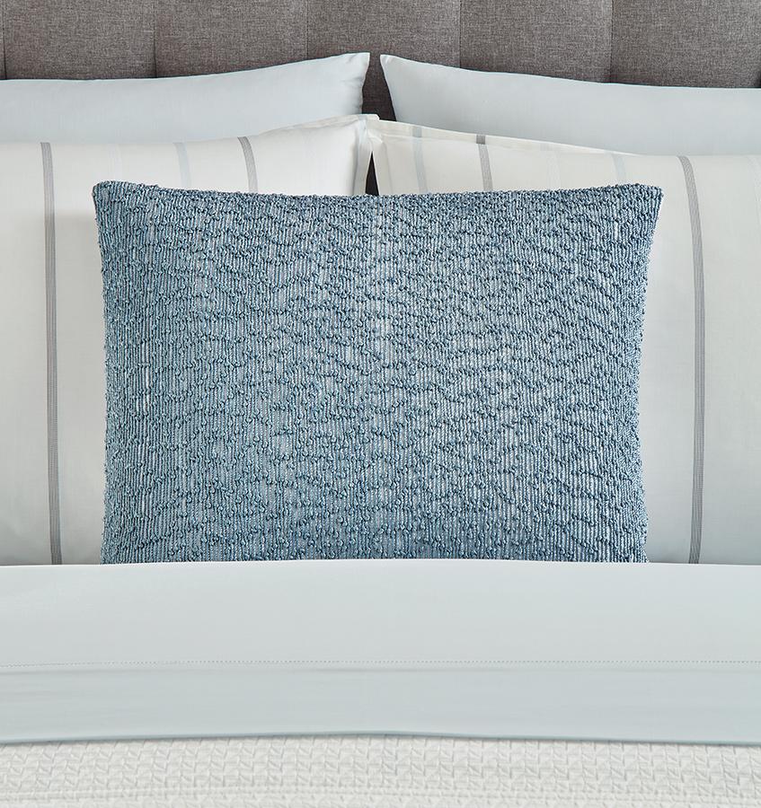 Lesina  decorative  pillow  features  embroidered  threads  woven on a crisp white cotton-linen base.