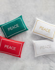 SFERRA Peace Decorative Pillows feature uplifting words or phrases in colored satin stitch embroidery on pure linen