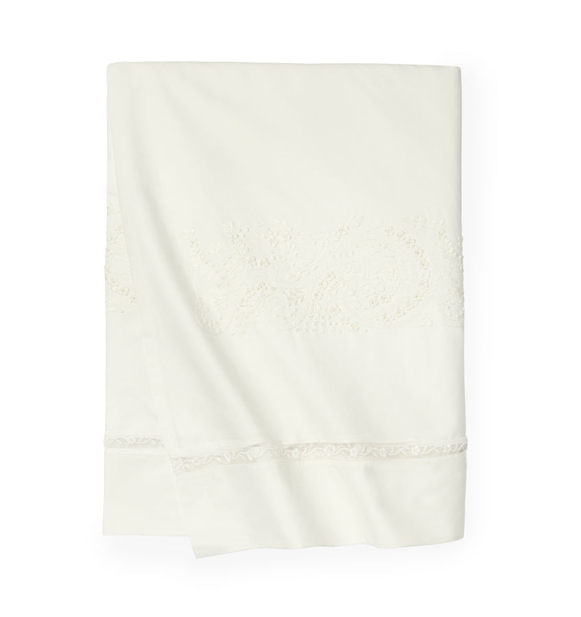 A luxury SFERRA Francesca bed skirt in an ivory hand-embroidered cotton with a lace inset.