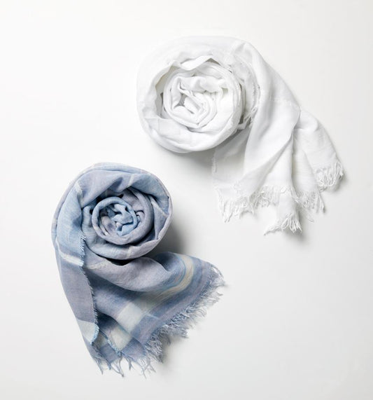 Two SFERRA Garda Scarves rolled up and set against a white background.