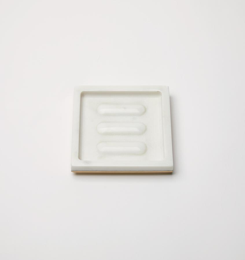 A rectangular marble SFERRA Pietra soap dish against a grey background.