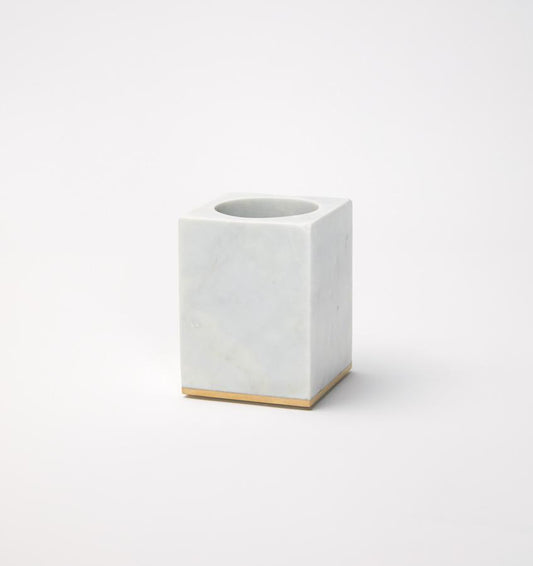Gold-trimmed marble toothbrush holder against a white background.