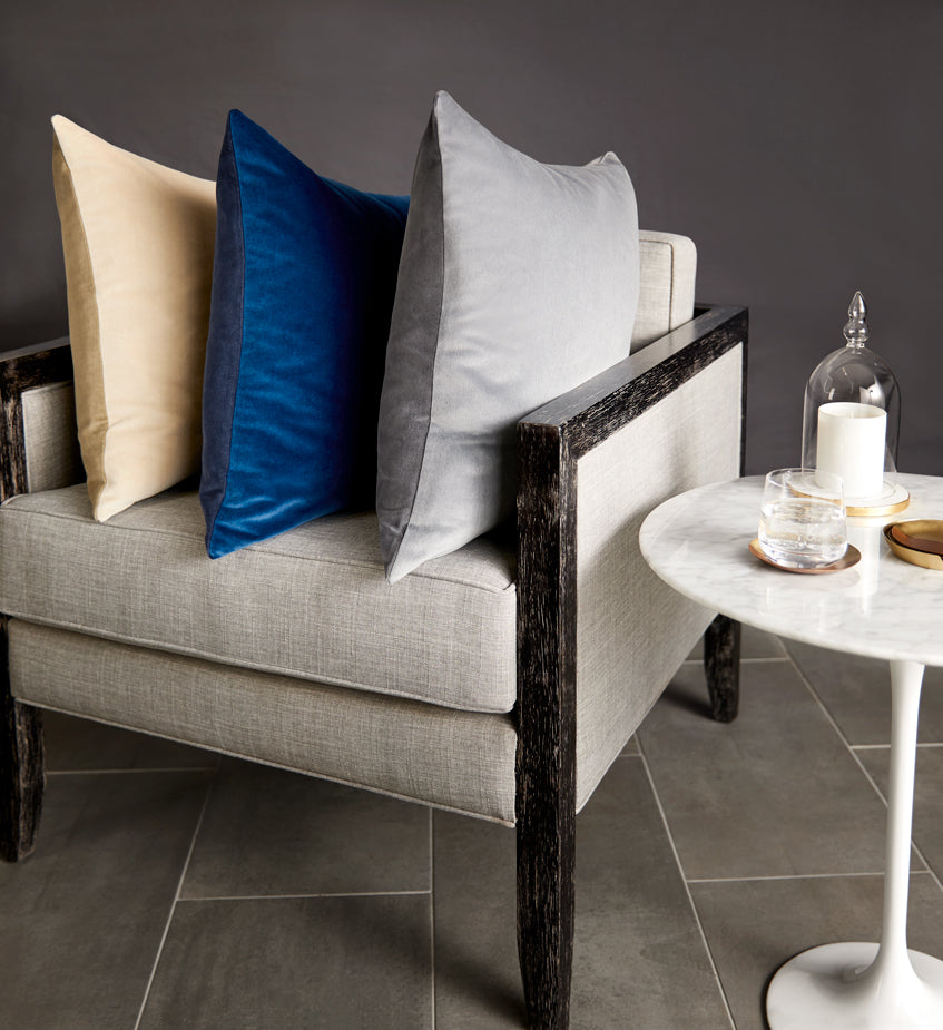 Velluto is a versatile, two-toned velvet decorative pillow in a rich color palette of blues, greys and beige.