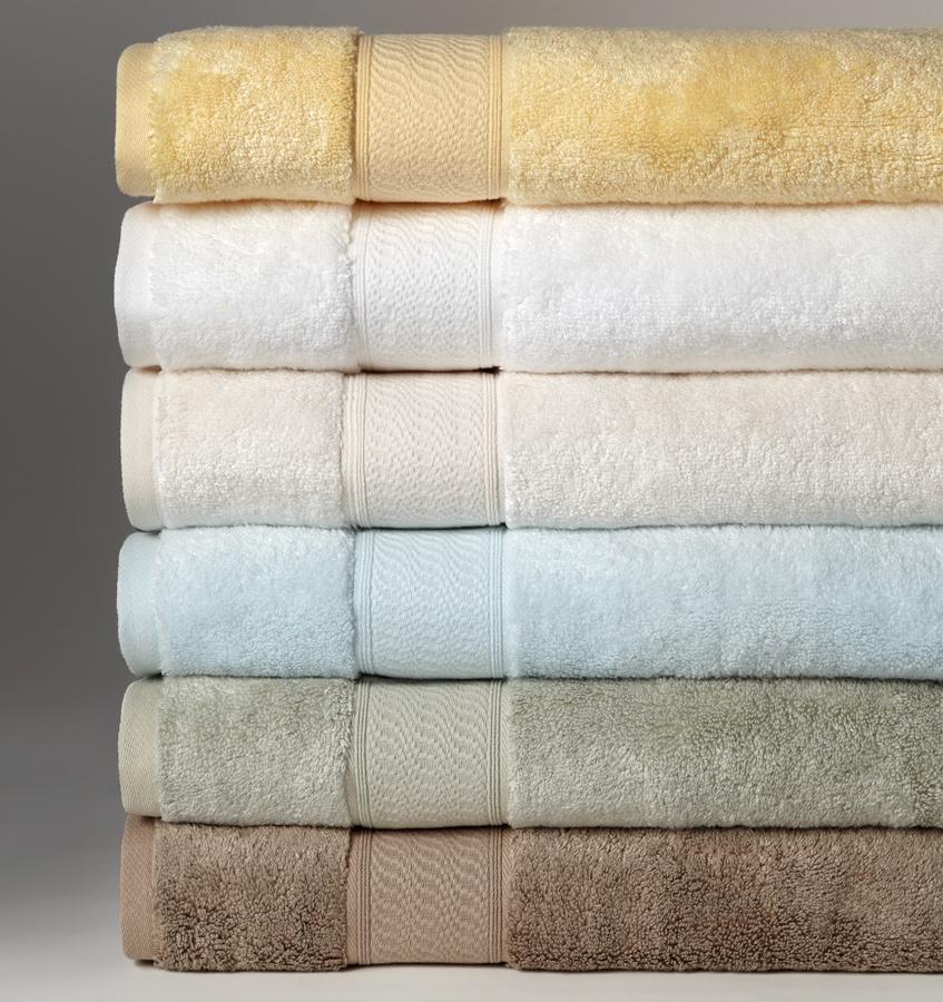 A stack of multi-colored SFERRA Amira luxury bath towels.