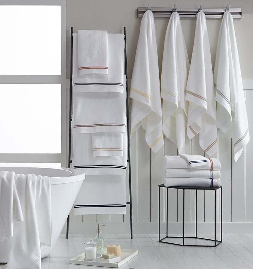 SFERRA Aura bath towels with multi-colored embroidered striped borders.