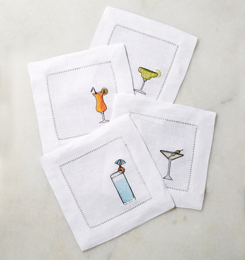 SFERRA Bevande cocktail napkins feature a Martini, Margarita, Orange Crush and Blue Hawaiian on hemstitched linen napkins.