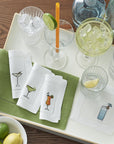 SFERRA Bevande cocktail napkins feature a Martini, Margarita, Orange Crush and Blue Hawaiian on hemstitched linen napkins.