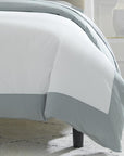 Casida Duvet Cover is minimal with its contrast color border in sateen appliqué along one side, and solid sateen on the reverse.