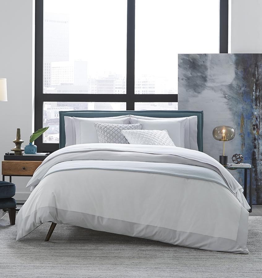 Casida Duvet Cover is minimal with its contrast color border in sateen appliqué along one side, and solid sateen on the reverse.