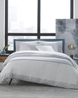 Casida Duvet Cover is minimal with its contrast color border in sateen appliqué along one side, and solid sateen on the reverse.
