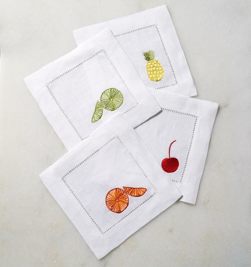 SFERRA Frutta cocktail napkins feature ambrosial fruits on white hemstitched linen napkins.