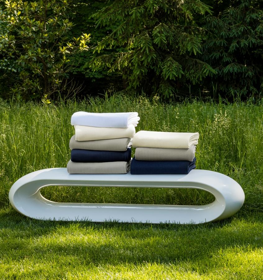 The SFERRA Grant classic cotton blanket in white, ivory, grey, and navy.