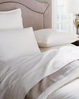 A bed with SFERRA Tesoro luxury bedding, crafted from the finest cotton in the world.